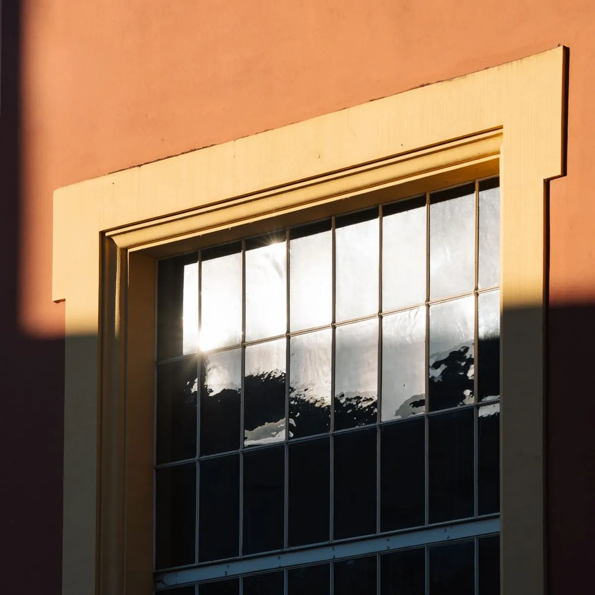Window glass reflecting bright summer sun